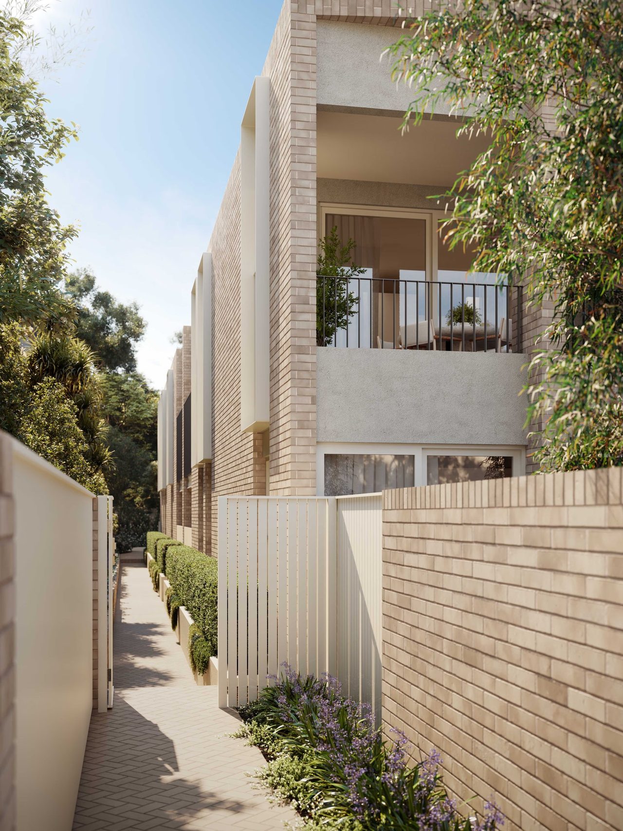 A planted pedestrian entrance beside DECA’s textured brick facade. Artist impression.